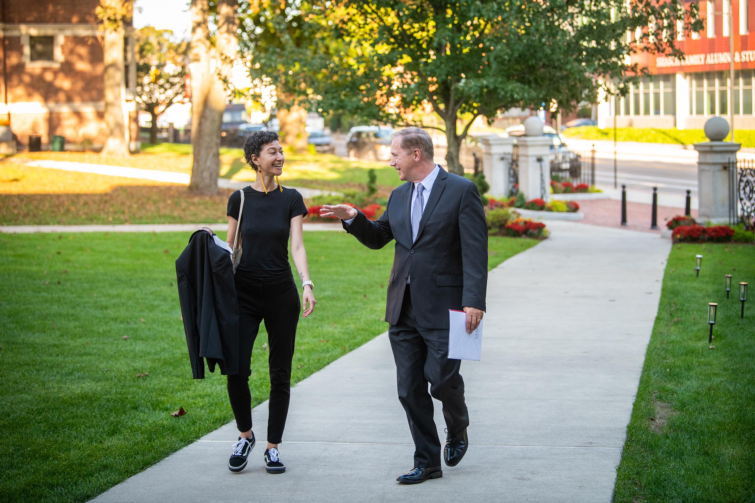 Physicist Chanda Prescod-Weinstein walking with President David Fithian before presenting Clark’s annual Presidential Lecture.