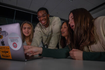 four students with laptops