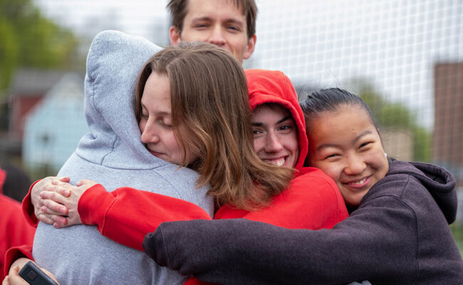 Students embracing after an Earth Day race event
