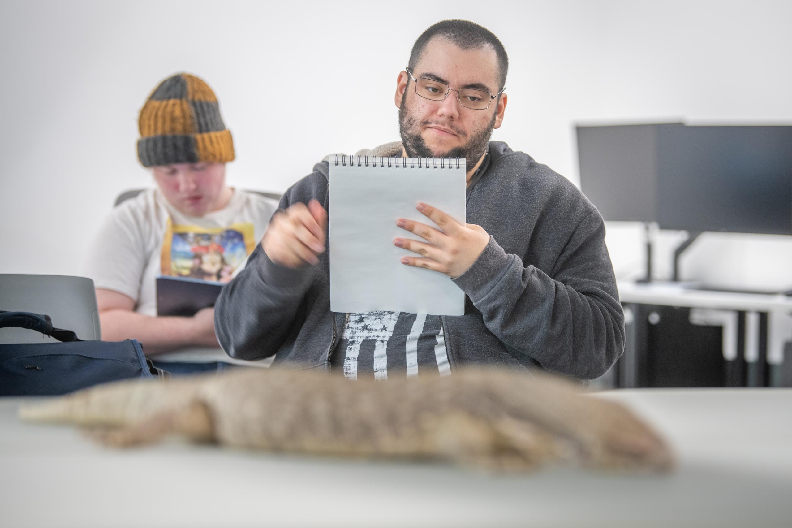 A student sketches a reptile