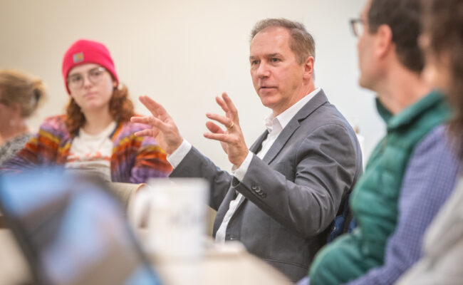 President David Fithian meets with students working on an environmental restoration initiative