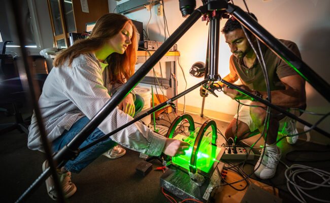 Lily Carey '25 and Balaram Desai '24 work in the Kudrolli Physics Lab on a robotic experiment.