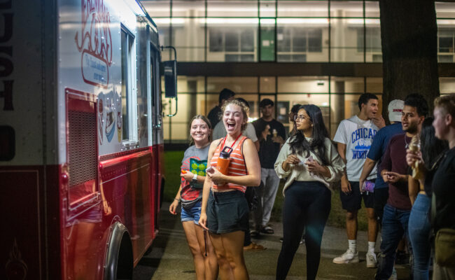 Clark students in line at a food truck during a Saturday evening event