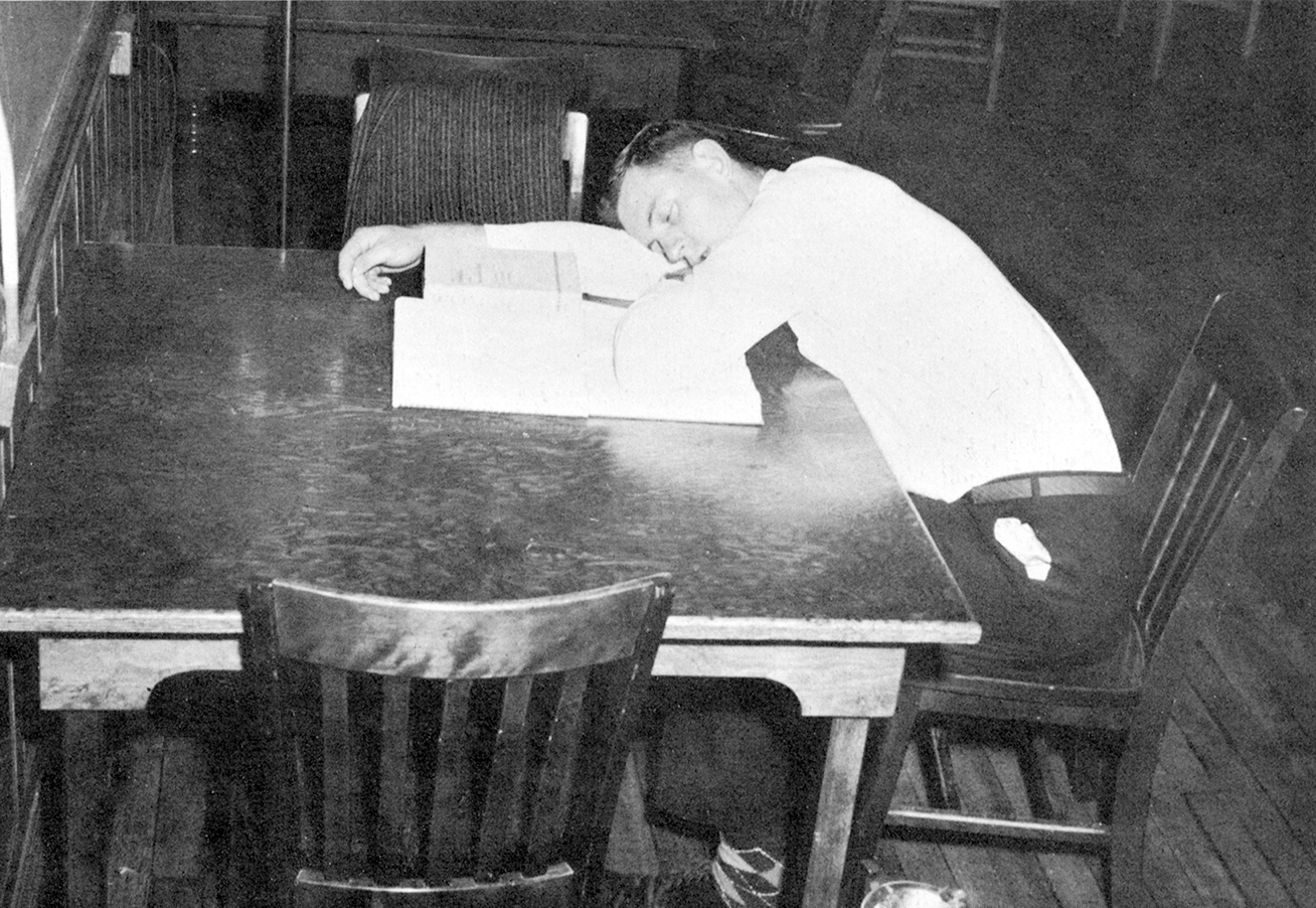 Student asleep in the library - photo from 1960 Clark University yearbook