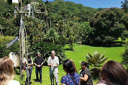 A group of people gather at a climate station in Hawaii