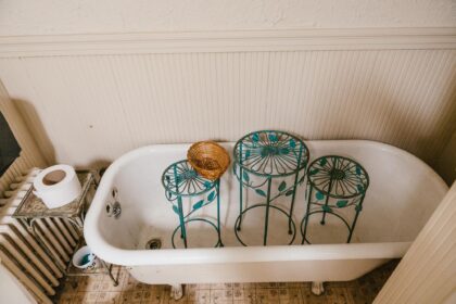 claw foot tub with plant stands inside it