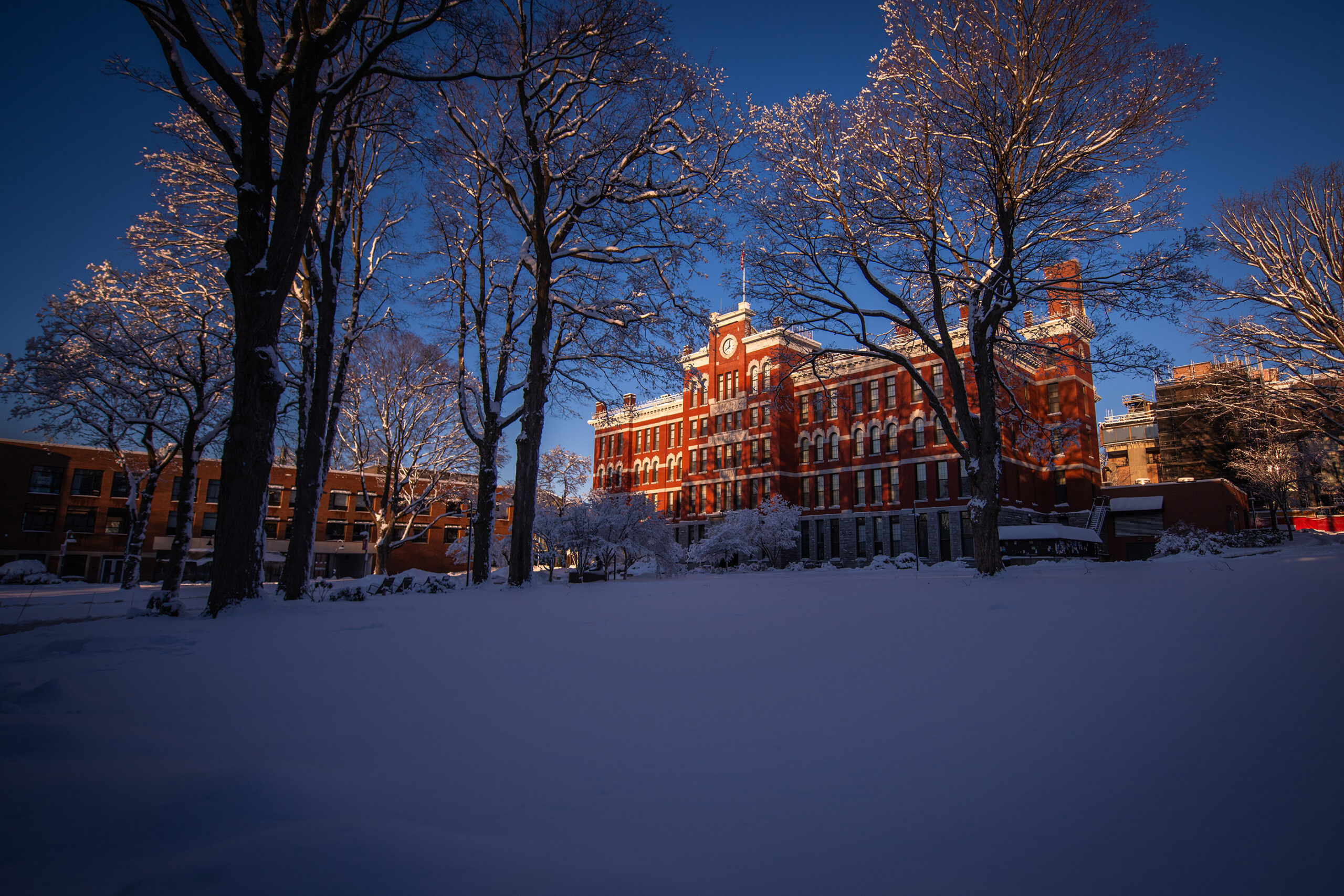 Jonas Clark Hall and the campus green at Clark University after the first snowfall of 2024