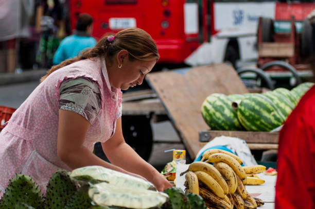 A woman sells her produce at a farmers market in Bogotá.