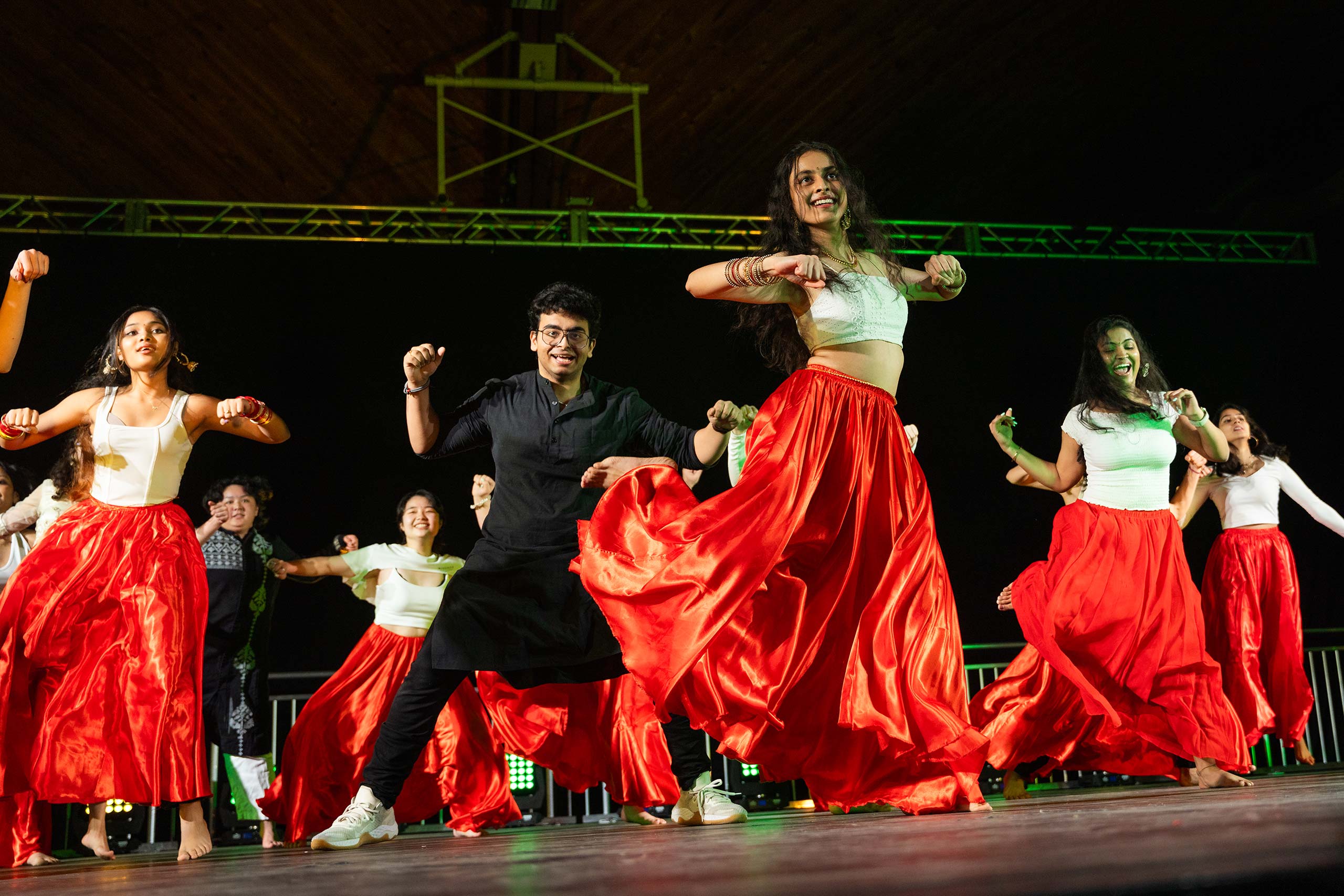 Students wearing long skirts and kurtas light during a performance at the 2024 Gala event