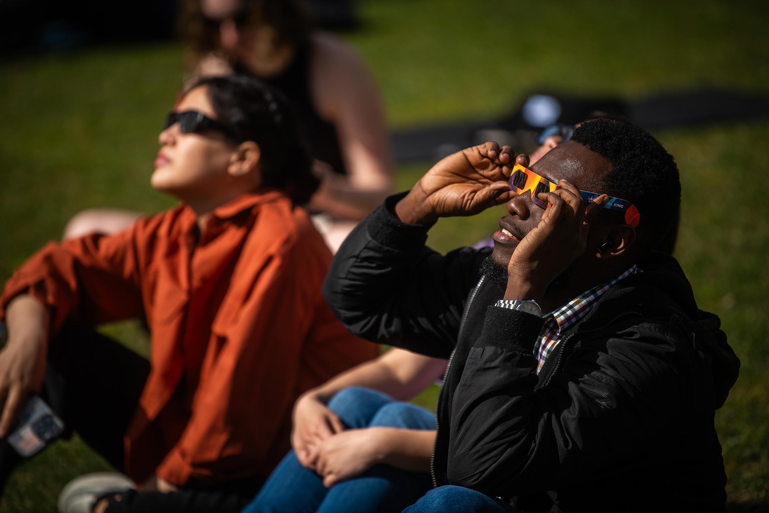 Students watch the partial solar eclipse on April 8, 2024, on the Clark University campus