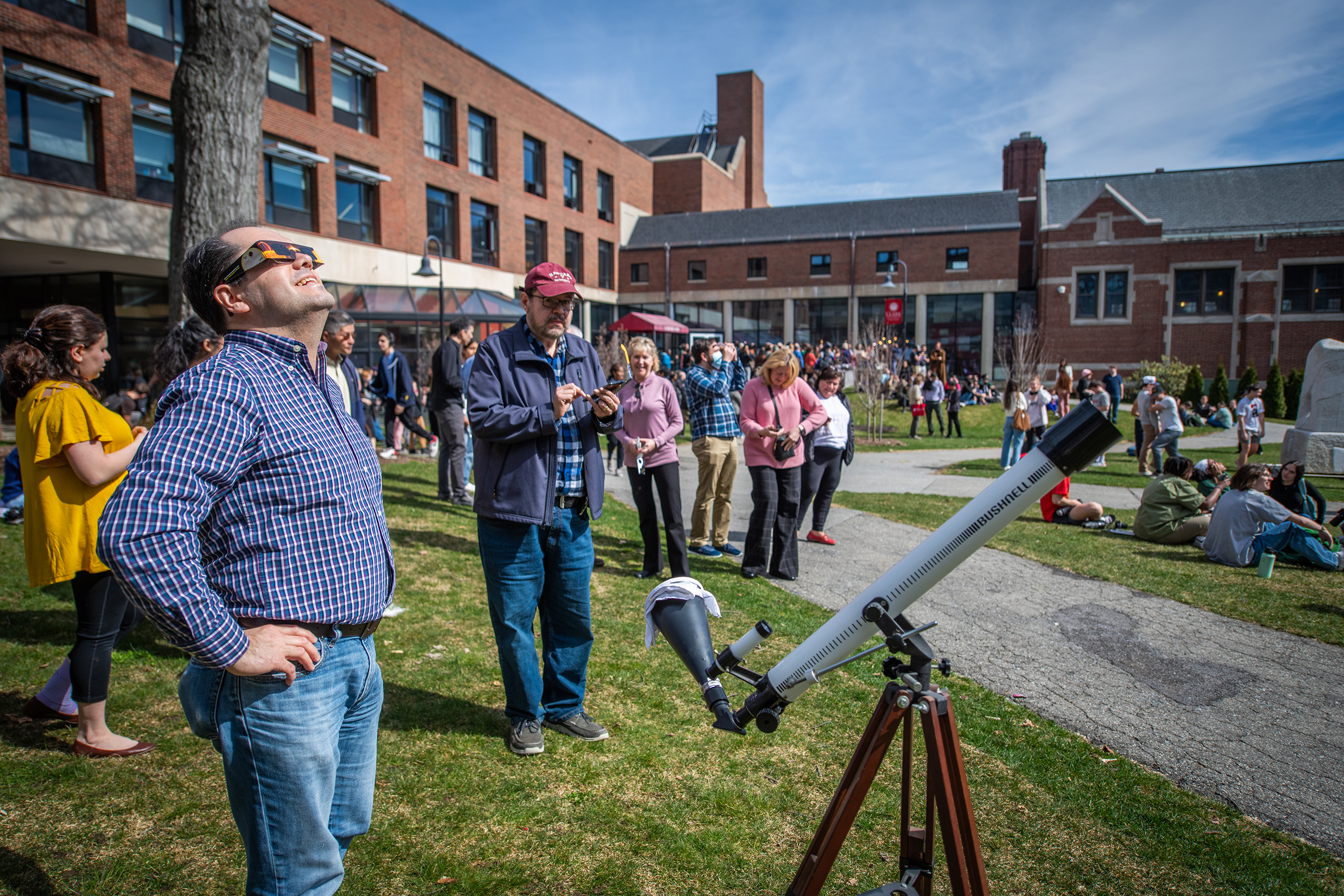 Students watch the partial solar eclipse on April 8, 2024, on the Clark University campus