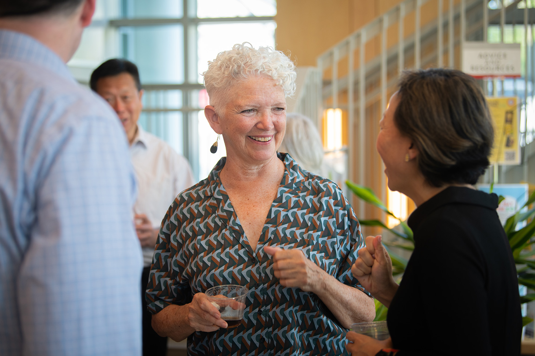 Mary-Ellen Boyle, center, shares a laugh with fellow School of Management professor Jing Zhang at the May 7 reception for retiring faculty members.